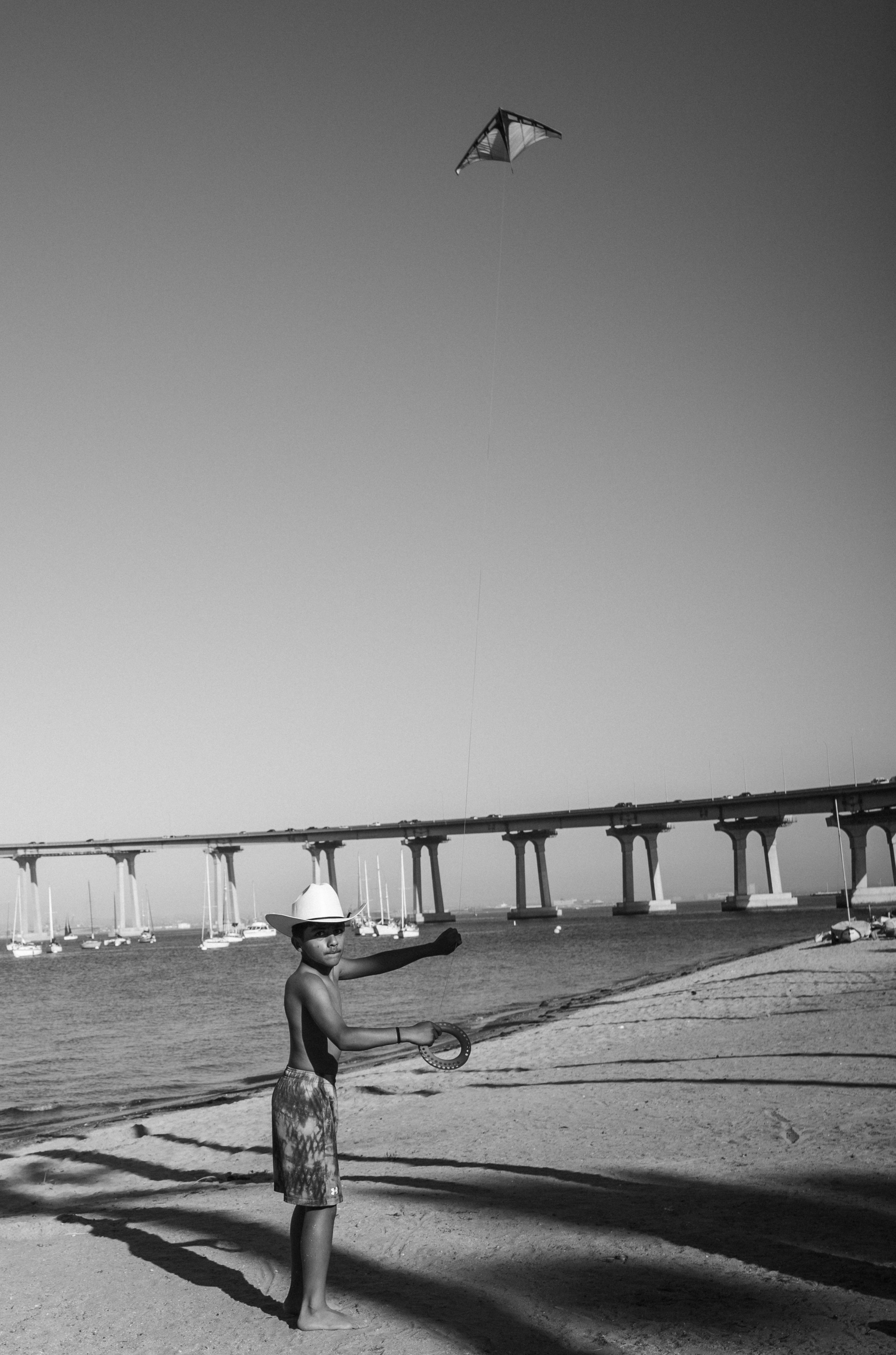 Boy in cowboy hat flying a kite